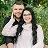 Texas wedding photographer smiling outdoors with her partner in front of green foliage.
